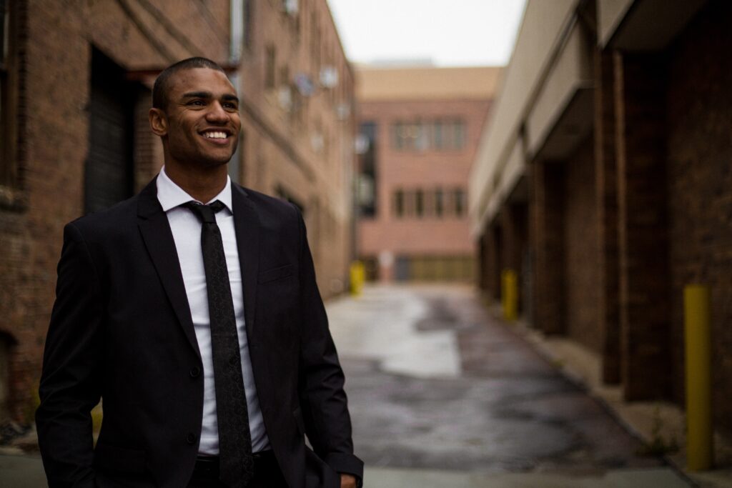 Man smiling in suit walking to work