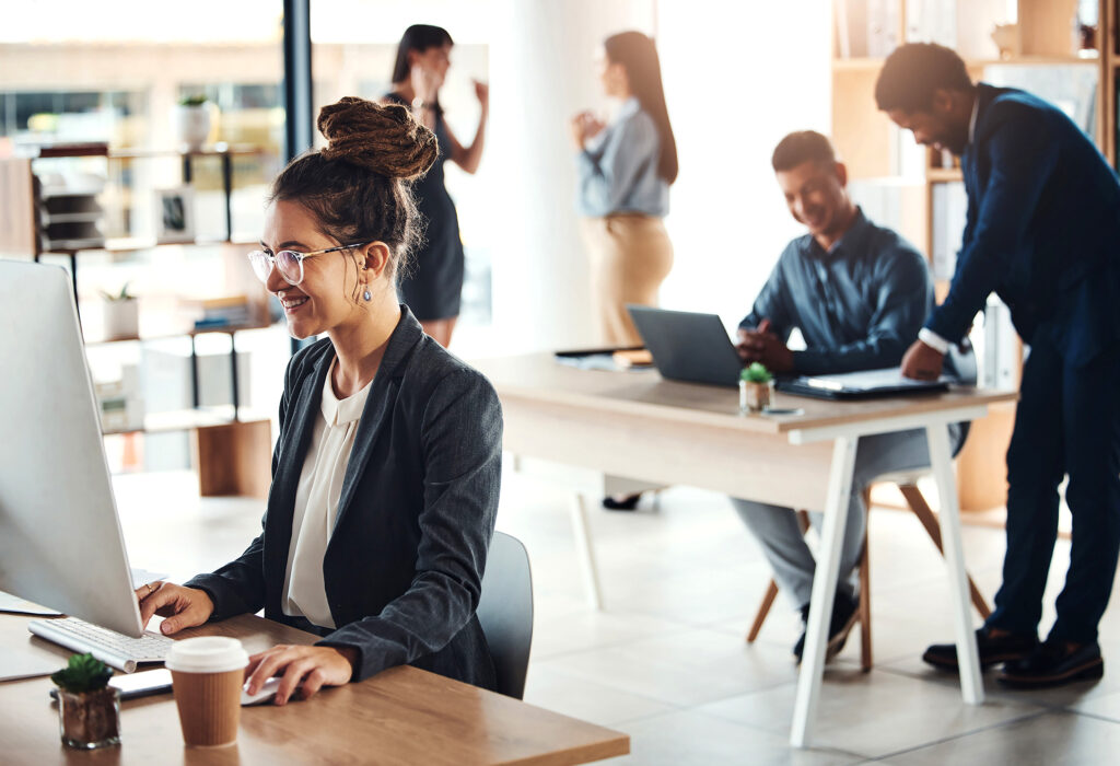 Woman at computer desk smiling